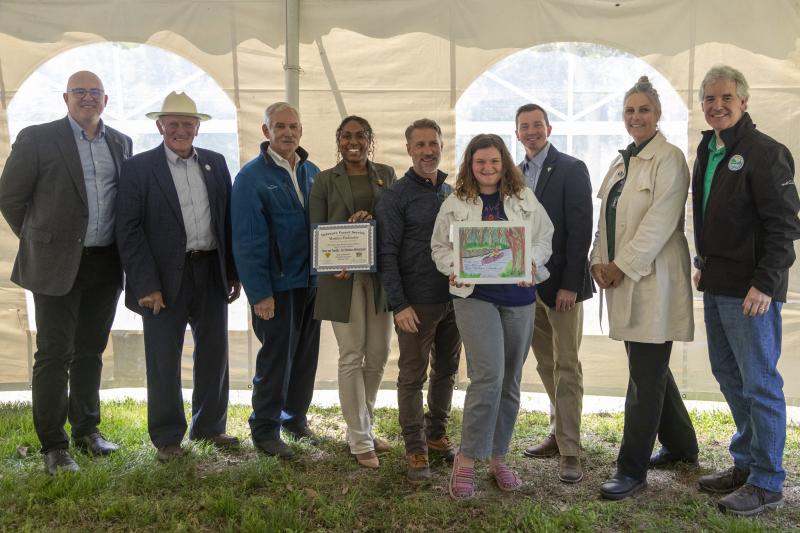 Madelyn Fischinskie was recognized with other contest winners at an April 26 celebration at Abbott’s Mill Nature Center. Gathered are (l-r) Sen. Russ Huxtable, D-Lewes; Sen. Dave Wilson, R-Lincoln; Secretary of Agriculture Michael T. Scuse; Director of Agricultural and Natural Resource Affairs for the Office of the Governor Nikko Brady; Delaware Department of Education Secretary Mark Holodick; Madelyn; State Forester Kyle Hoyd; Delaware Nature Society Executive Director Jennifer Adkins; and Delaware Department of Natural Resources and Environmental Control Secretary Shawn Garvin.